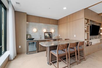 Game Lounge with billiards, shuffleboard, wet bar, and multi-sport golf simulator at Lilia Apartments in Lilydale, MN 55118